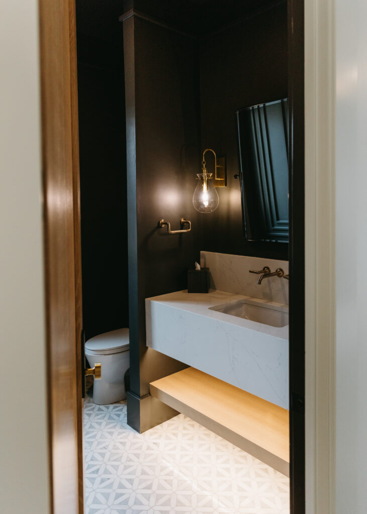 Moody powder bathroom with dark paint and custom vanity